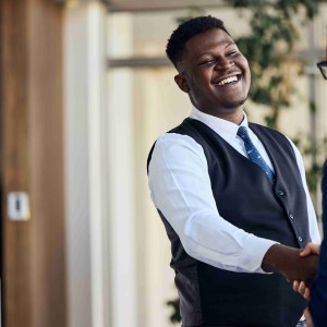 Cheerful professionals shaking hands in a modern b